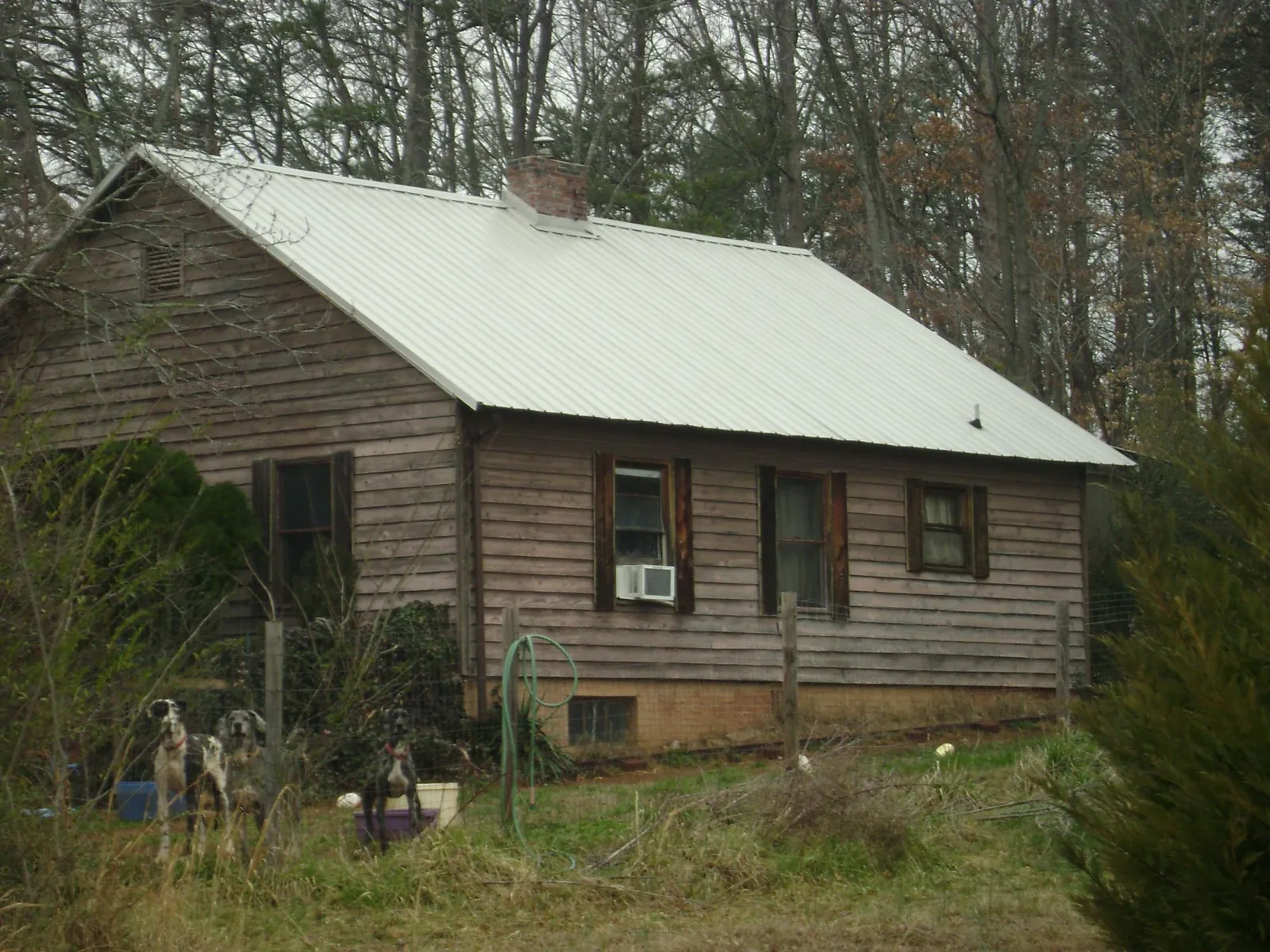 White metal roof on an old wood sided farmhouse, from a Metal Roof Installation job in Monee